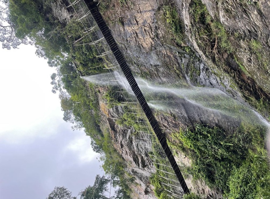 Waterfall and canopy bridge in the lush Amedzofe forest