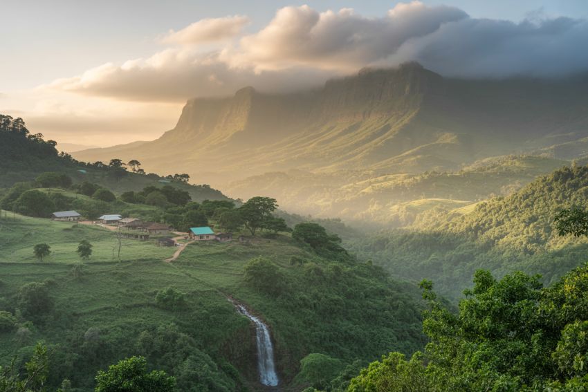 Golden light over the Amedzofe escarpment and waterfall at dusk